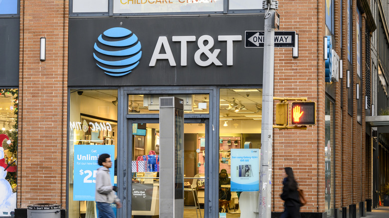 front of AT&T building with person walking outside it