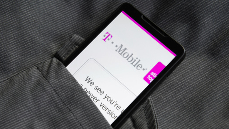 smartphone showing T-mobile web page pulled up, phone sticking out of pocket