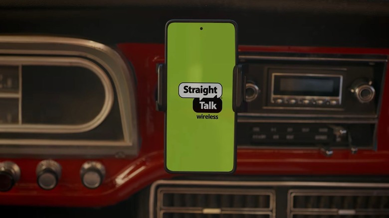 Straight Talk Wireless logo on a smartphone mounted in a car