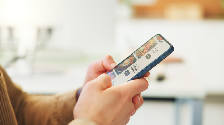Person using a smartphone to browse while in a public setting