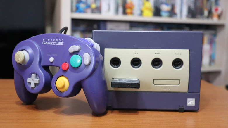 Nintendo GameCube console and controller on a wooden table