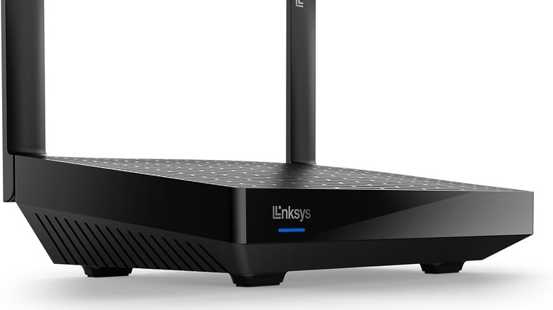 A Linksys router on a white background with blue light showing on the front of the device