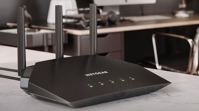 A Netgear Nighthawk RAX36 router sitting on a workspace counter, with an office in the background