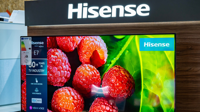A Hisense smart TV on display beneath Hisense signage