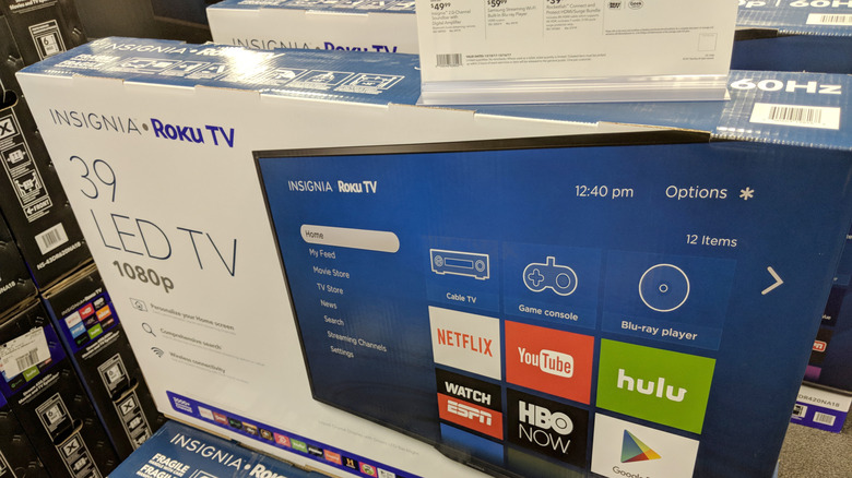 An Insignia smart TV in its packaging in a retail store