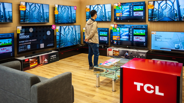 A customer standing in a TCL smart TV showroom