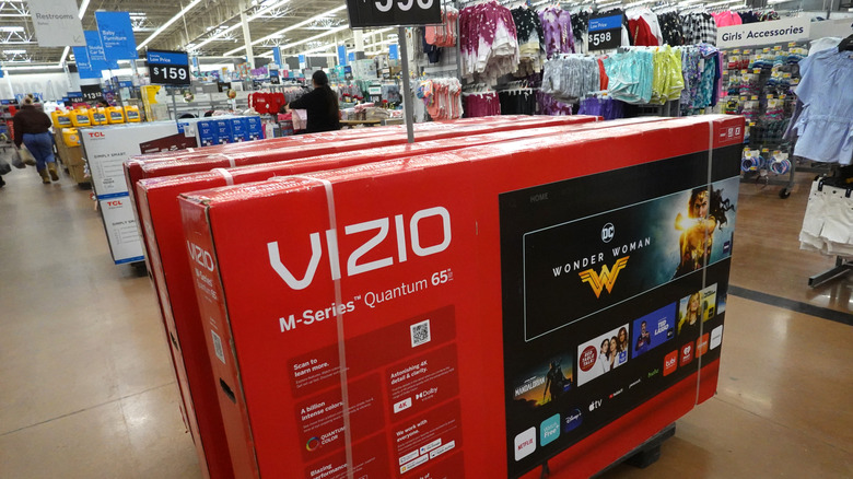 A stand full of Vizio smart TVs for sale at Walmart