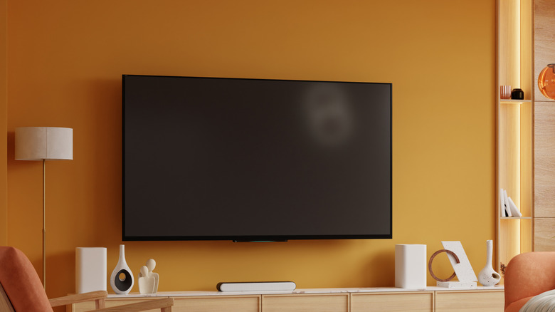 A TV mounted on the wall in a living room