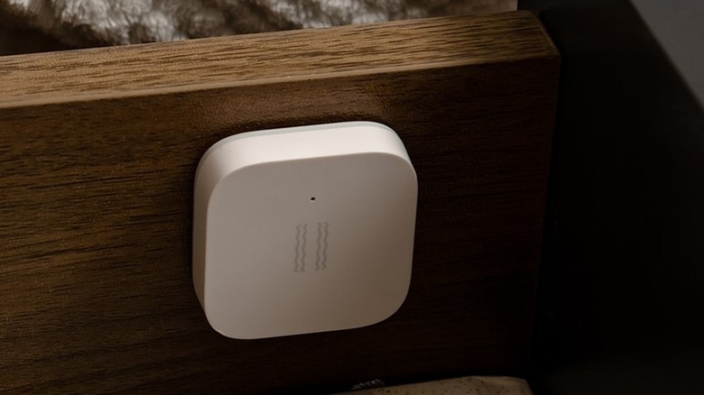 An Aqara Zigbee motion sensor installed in a drawer to monitor opening and closing.