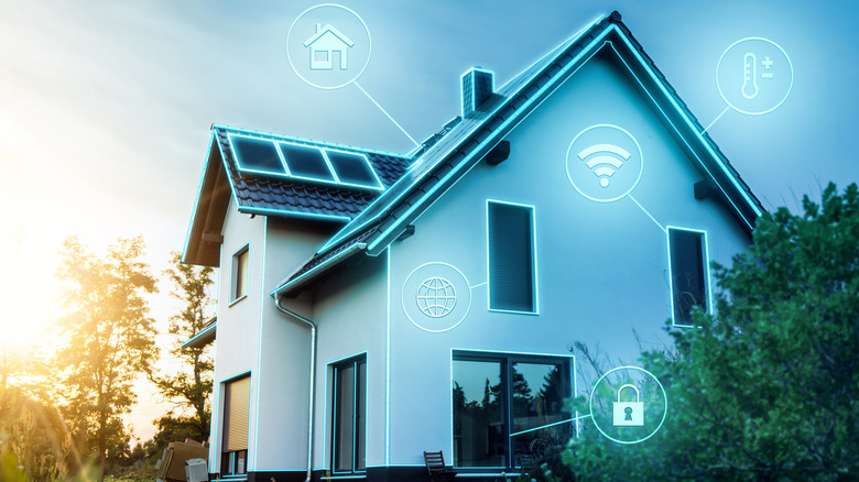 A modern smart home exterior with glowing icons representing the technology in use.