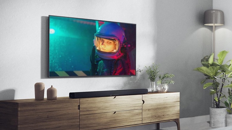 The Yamaha TRUE X BAR 40A set up on a TV stand below a wall-mounted TV.