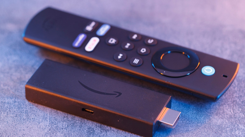 Close up on Amazon Fire Stick Tv device and remote controller for tv streaming.