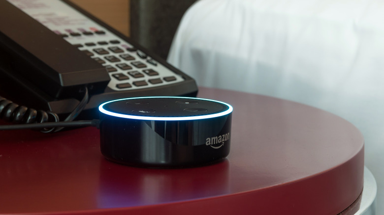 An Amazon Echo Dot on a bedside table