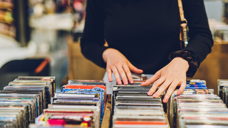 A person browsing through DVDs in a store