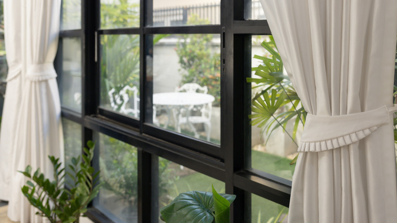 white curtains on a black glass window