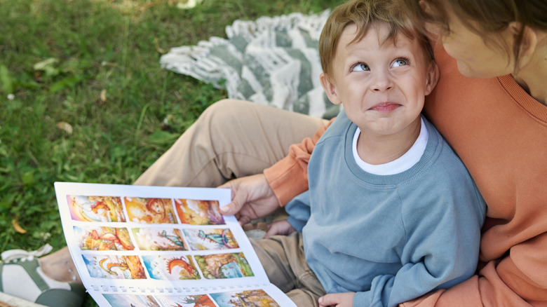 Child and parent reading custom-bound comic book
