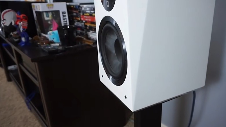 Large subwoofer on a stand in a gaming room