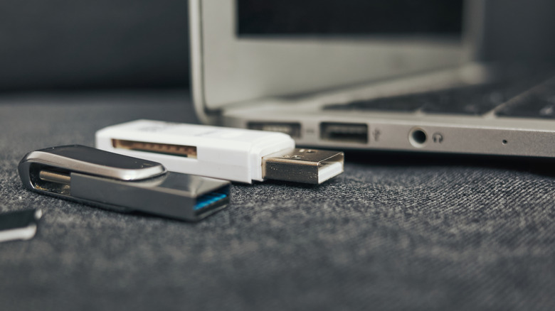 USB flash drives placed next to a laptop