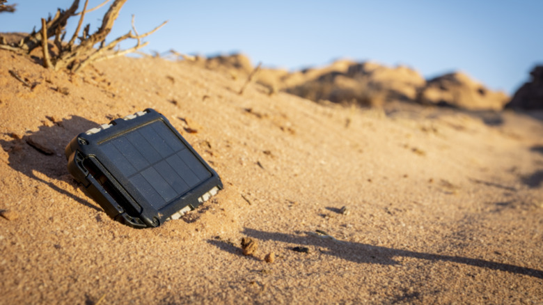 Portable solar panel in the heat and in the sand.