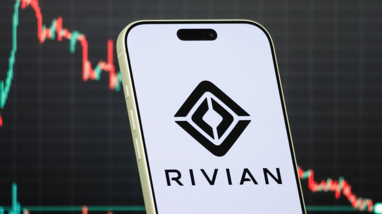 In this photo illustration, a smartphone displays the logo of Rivian Automotive, Inc.