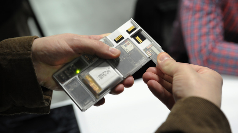 Close-up of a person assembling a Project Ata prototype at an event