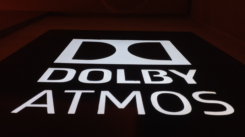The Dolby Atmos logo and lettering lit up against a dark background