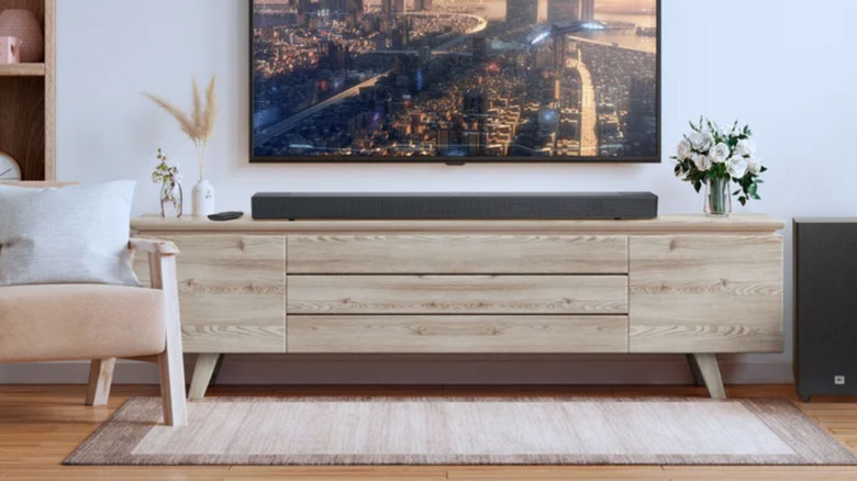 The JBL SB595 soundbar and subwoofer set up with a TV