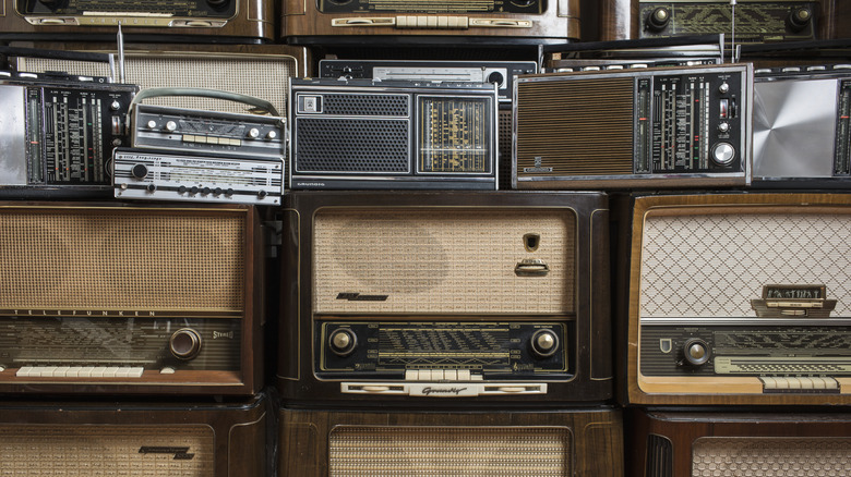 A series of vintage radios stacked on top of each other