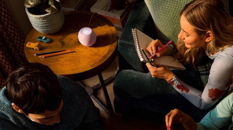 People gathered around a HomePod mini 2