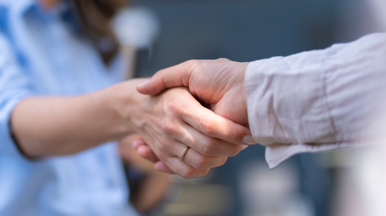 A male and a female hand in a handshake