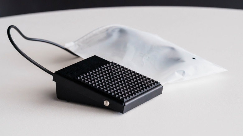 A foot pedal switch on a white surface