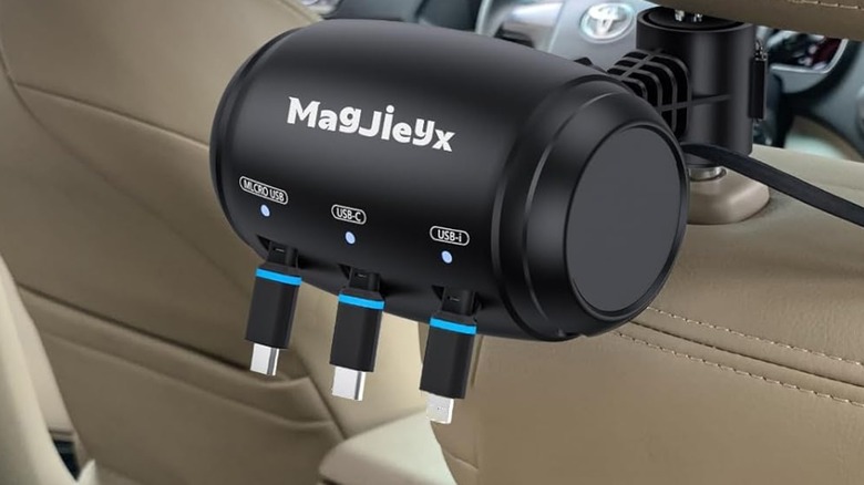 An Amazon promotional photo for the Magjieyx Retractable Car Station Box, the image showcases the charging station hanging from the back of the front passenger's seat headrest