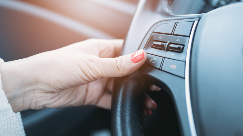 Pressing the phone button on a steering wheel
