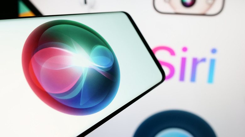 The Siri logo on a phone with lettering in the background