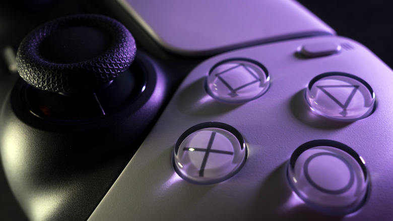An extreme close up of a PS5 controller's buttons and right joystick
