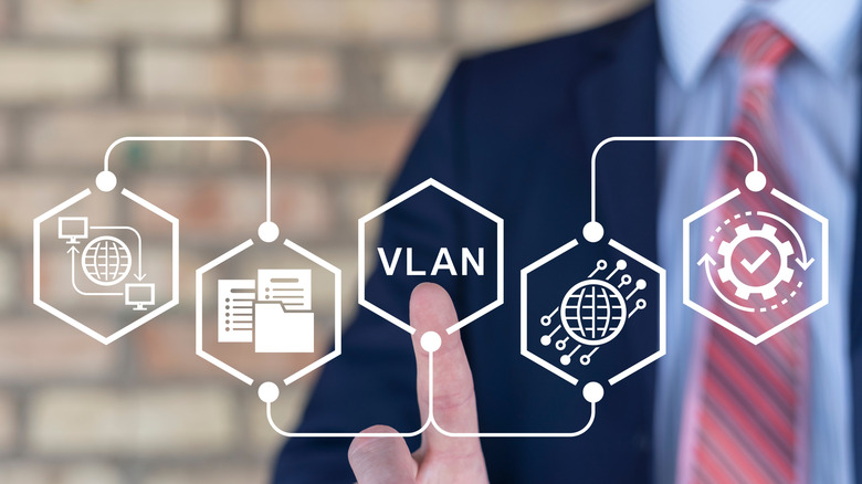 A business person presses points to the VLAN symbol on a VLAn diagram