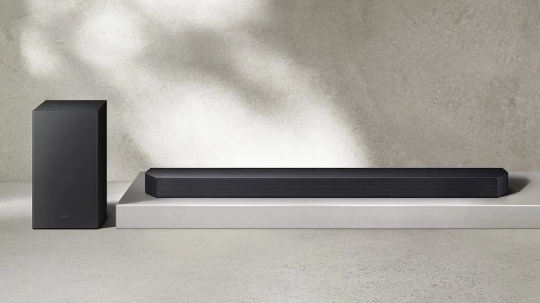 The Samsung HW-Q60CF 3.1.2 Ch Soundbar with a subwoofer against a grainy background