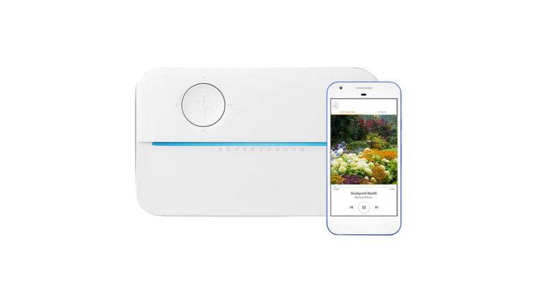 The Rachio 3 Smart Sprinkler Controller beside a smartphone showing a garden