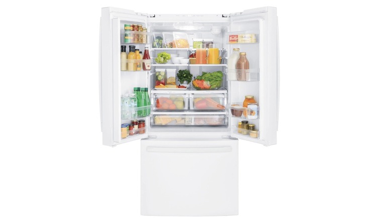 A white GE GWE19JGLWW refrigerator on a white background, open to reveal several food items