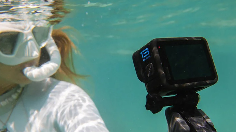 A woman snorkeling underwater with a GoPro Hero13