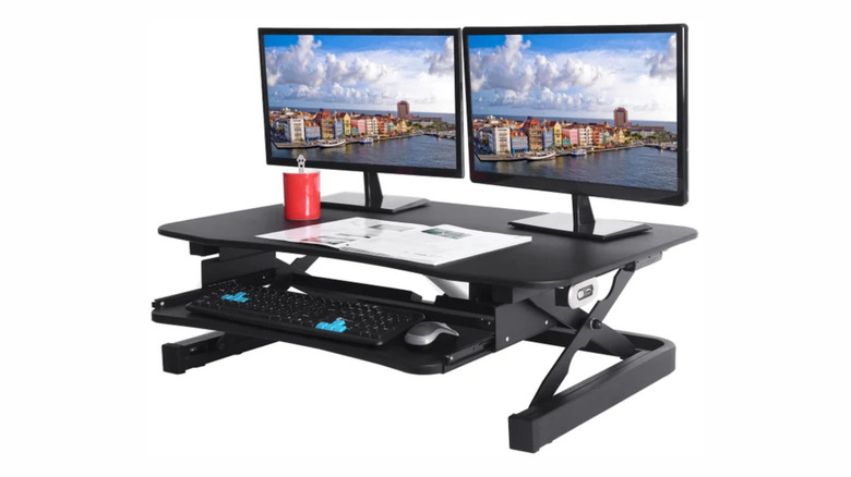 The ApexDesk ZT electric desk riser with two monitors and a keyboard and mouse