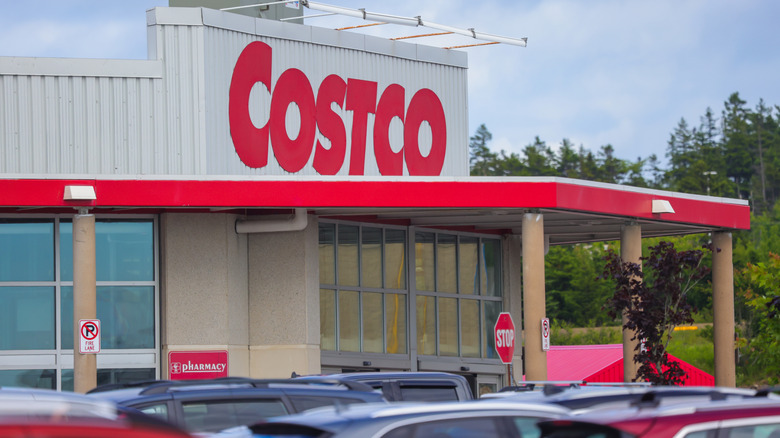 The entrance to a Costco with vehicles in the front parking lot
