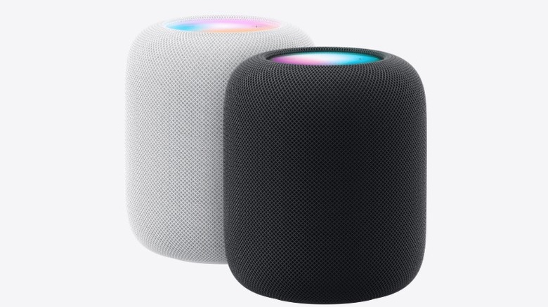 White and black Apple HomePod devices on a white background