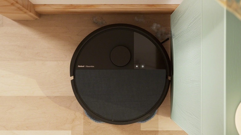 The iRobot Roomba Plus 507 Combo Robot Vacuum & Mop cleans a corner of the floor.