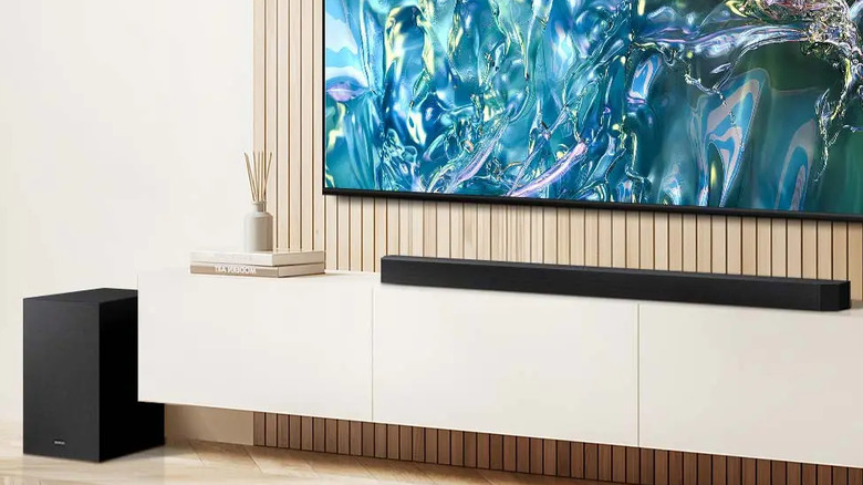 The Samsung HW-B73CD placed below a wall-mounted TV on an entertainment center