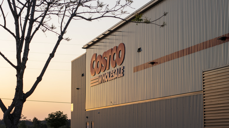 Costco signage on the side of a building at sunset