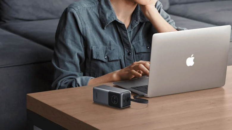 The Ugreen Nexode 20,000 mAh power bank next to a laptop