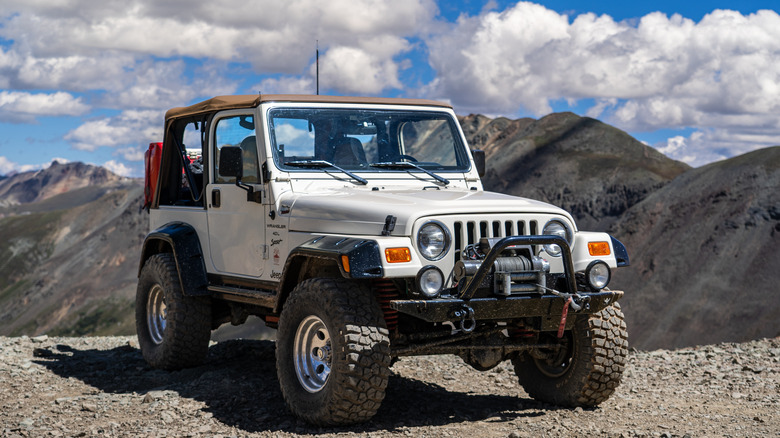 An off road vehicle on top of a hill