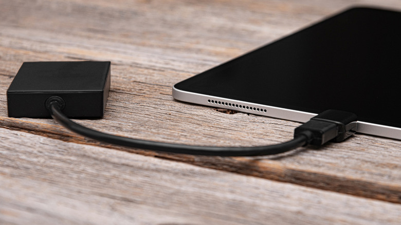 An external hard drive connected to a tablet using an adapter