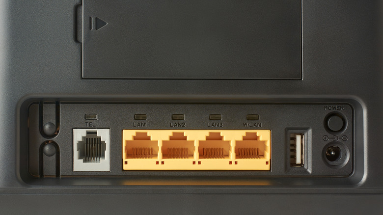 Ports on the back of a black Wi-Fi router